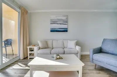 a living room with a couch and a coffee table at 1104 West 3 Bedrooms including 2 King Bedrooms and Custom Room in Panama City Beach