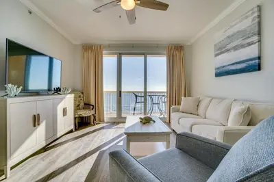 a living room with a couch and a flat screen tv at 1104 West 3 Bedrooms including 2 King Bedrooms and Custom Room in Panama City Beach