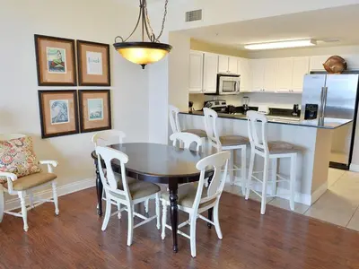 a kitchen and dining room with a table and chairs at 1202 East Calypso Gulf Front 3Bedroom 2 Bath in Panama City Beach