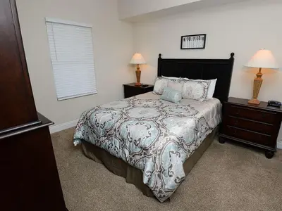 a bedroom with a bed with two night stands and two lamps at 1202 East Calypso Gulf Front 3Bedroom 2 Bath in Panama City Beach
