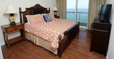 a bedroom with a bed and a flat screen tv at 1202 East Calypso Gulf Front 3Bedroom 2 Bath in Panama City Beach