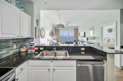a kitchen with a sink and a counter top at Calypso 2308 West Penthouse Views Totally Remodeled in Panama City Beach