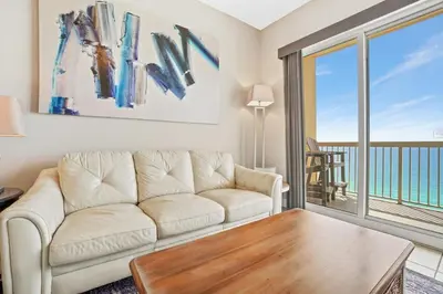 a living room with a couch and a table at Calypso 2306E Penthouse Condo 3BR 2BA Best Views Anywhere in Panama City Beach