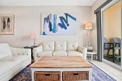 a living room with a couch and a table at Calypso 2306E Penthouse Condo 3BR 2BA Best Views Anywhere in Panama City Beach