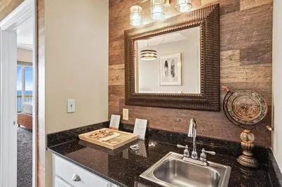 a kitchen with a sink and a mirror at Calypso 2306E Penthouse Condo 3BR 2BA Best Views Anywhere in Panama City Beach