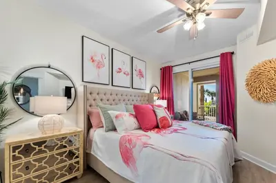 a bedroom with a bed and a mirror at Grand Panana 106 in Panama City Beach