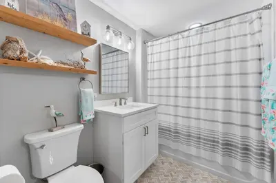 a bathroom with a white toilet and a sink at Grand Panana 106 in Panama City Beach