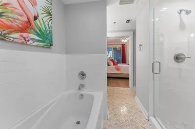 a white bathroom with a tub and a shower at Grand Panana 106 in Panama City Beach