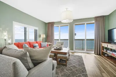 a living room with a couch and a television at Calypso 2201E 3BR 3BA corner unit 2 sets of beach chairs in Panama City Beach