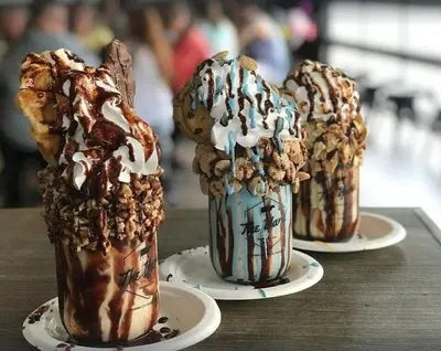 three chocolate milkshakes on plates on a table at Calypso 2201E 3BR 3BA corner unit 2 sets of beach chairs in Panama City Beach