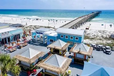 an aerial view of a beach with a pier at Grand Panama 205 in Panama City Beach