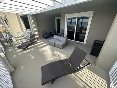 a view of a balcony with a chair and a couch at Grand Panama 205 in Panama City Beach