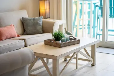 a living room with a couch and a coffee table at Calypso 2006W Gulf Front and Newly renovated Custom Shower in Panama City Beach