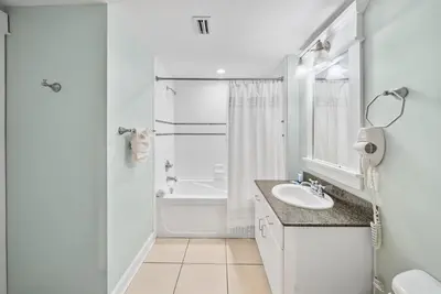 a white bathroom with a sink and a shower at Grand Panama 207 in Panama City Beach