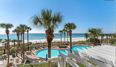a view of the beach from the balcony of a resort at Grand Panama 207 in Panama City Beach