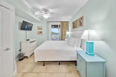 a bedroom with a bed and a television in it at Grand Panama 207 in Panama City Beach