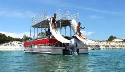 three people on a boat in the water at Calypso 1801W Corner Unit Incredible wrap around Balcony in Panama City Beach