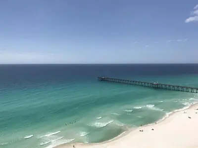 an aerial view of a beach with a pier at Calypso 1801W Corner Unit Incredible wrap around Balcony in Panama City Beach