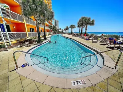 a swimming pool at a resort with the ocean at Calypso 1801W Corner Unit Incredible wrap around Balcony in Panama City Beach