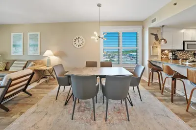 a kitchen and dining room with a table and chairs at Grand Panama 501 in Panama City Beach