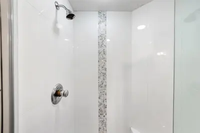 a shower in a bathroom with a glass door at Grand Panama 501 in Panama City Beach