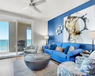 a blue living room with a blue couch and chairs at Grand Panama 604 in Panama City Beach
