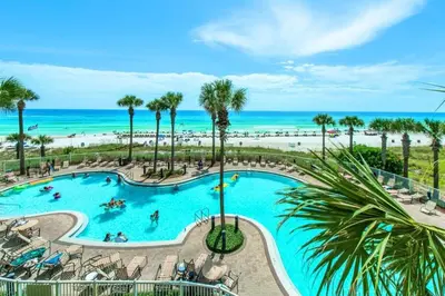 an overhead view of a swimming pool with the beach at Grand Panama 604 in Panama City Beach