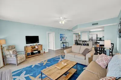 a living room with a couch and a table at Calypso 1601W Gulf Front Corner unit Fantastic Specials in Panama City Beach