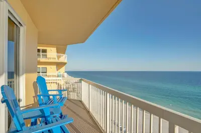 two blue chairs on a balcony looking out at the ocean at Calypso 1601W Gulf Front Corner unit Fantastic Specials in Panama City Beach