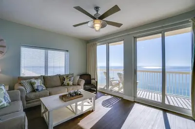 a living room with a couch and a table at Calypso 1401E 3BR 3BA Corner unit Direct Gulf Front High Demand in Panama City Beach