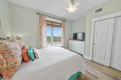 a bedroom with a white bed and a window at Grand Panama 809 in Panama City Beach