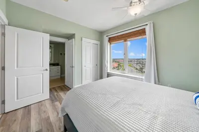 a bedroom with a bed and a large window at Grand Panama 809 in Panama City Beach