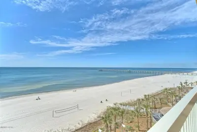 a view of the beach from the balcony of a condo at Calypso 1209W Corner 3BR 3BA 2 sets of beach service in Panama City Beach