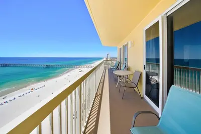 a balcony with a view of the beach and the ocean at Calypso 1209W Corner 3BR 3BA 2 sets of beach service in Panama City Beach
