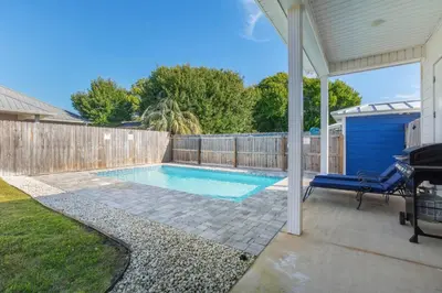 a swimming pool in the backyard of a house at Laid-Back - Private Pool, 4 Min Walk to Beach, Close to 30A, FREE Daily Activities in Panama City