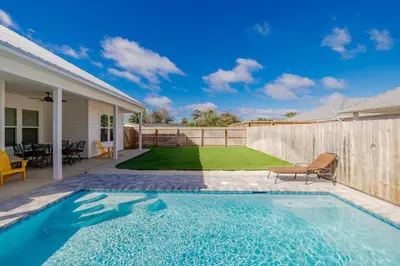 a swimming pool in the backyard of a house at Laid-Back - Private Pool, 4 Min Walk to Beach, Close to 30A, FREE Daily Activities in Panama City