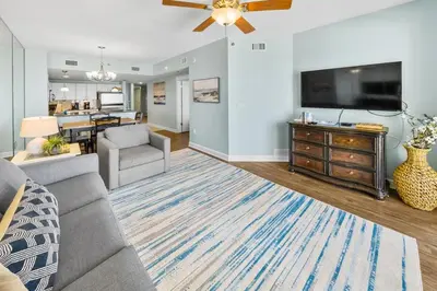 a living room with a couch and a flat screen tv at Grand Panama 902 in Panama City Beach