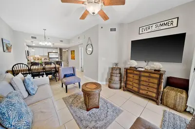 a living room with a large flat screen tv at Grand Panama 904 in Panama City Beach