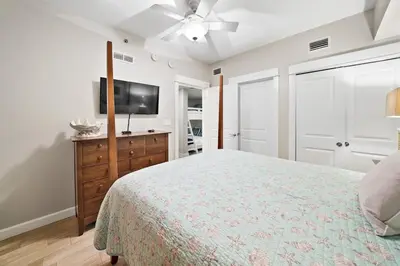 a bedroom with a bed and a flat screen tv at Grand Panama 904 in Panama City Beach