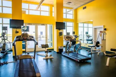a gym with several treadmills and exercise machines at Grand Panama 904 in Panama City Beach