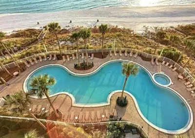 an overhead view of a swimming pool next to the beach at Grand Panama 909 in Panama City Beach