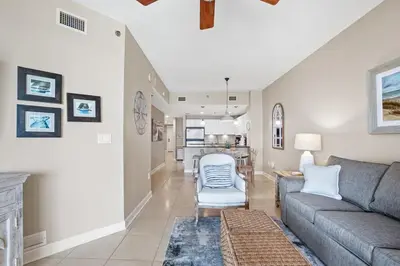 a living room with a couch and a table at Grand Panama 1003 in Panama City Beach