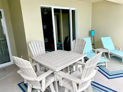 a white table and chairs sitting on a porch at Grand Panama 1003 in Panama City Beach