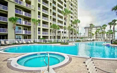 a swimming pool in front of a apartment building at Grand Panama 1204 in Panama City Beach