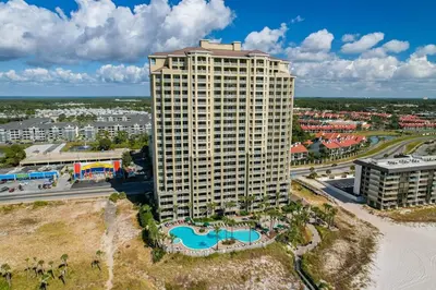 an aerial view of a tall building with a pool at Grand Panama 1204 in Panama City Beach