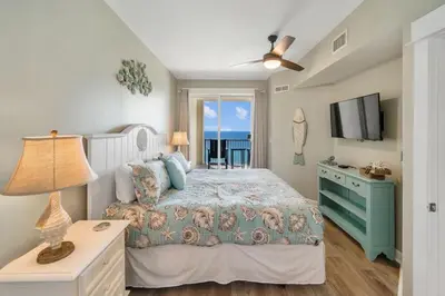 a bedroom with a bed and a television in it at Grand Panama 1204 in Panama City Beach