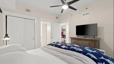 a bedroom with a bed and a flat screen tv at Grand Panama 1307 in Panama City Beach