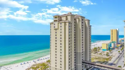 a tall building next to the beach and the ocean at Grand Panama 1307 in Panama City Beach