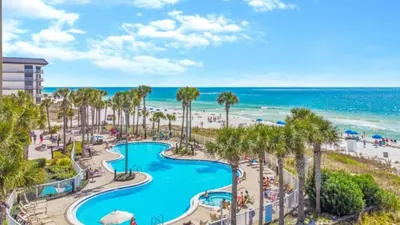 an aerial view of a resort with a pool and the beach at Grand Panama 1307 in Panama City Beach