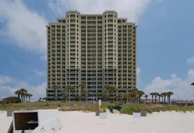a tall building on the beach with a building at Grand Panama 1405 in Panama City Beach